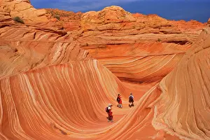 Approximately: The Wave - with hikers - carved rock eroded into
