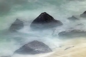 Waves: Waves crashing over lava rocks on shoreline of Espanola