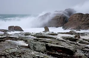 Crashing: Waves crashing against rocky coastline