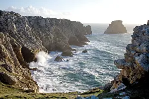 Crashing: Waves crashing against rocky coastline
