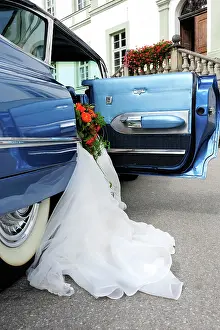 Celebrations: Wedding dress hanging out of a 1959 Chevrolet