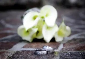 Rings: Wedding rings in front of a bridal bouquet