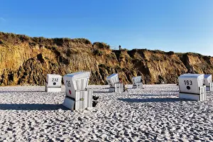 Chairs: White beach chairs, Red Cliff in the evening lig