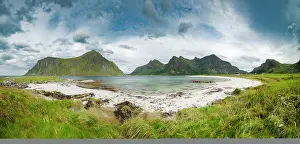 251020: White sandy beach in front of green mountain peaks