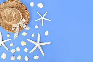 Seashells: White starfish, seashells and summer straw hat on
