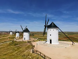 Wind: White windmills with black roofs standing in an