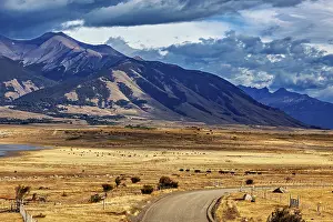 Roads: Wide plains with a winding road and a majestic mountain range in the background