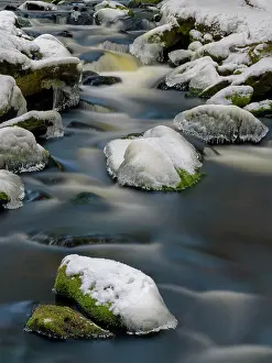 Blur: Wild river with ice and snow-covered stones in winter