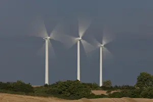 Generator: Wind Turbine generating power on a wind farm
