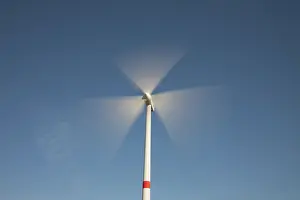 Generator: Wind Turbine generating power on a wind farm