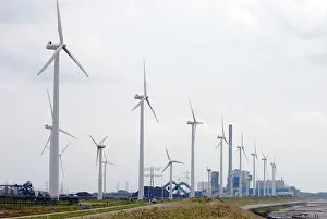 Fired: Wind Turbines and coal fired power station on the