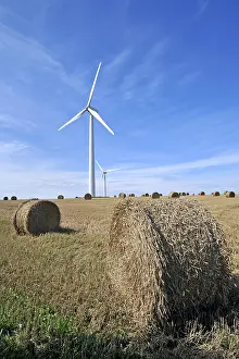 Wind: Wind turbines in mowed field with hay bales