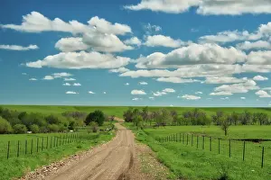 Fence: Winding road in Kansas Flint Hills