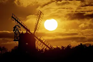 Norfolk: Windmill silhouetted at sunset with a red sky and