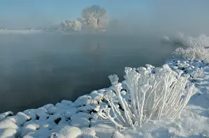 Hoar: Winter landscape showing a misty IJssel River with snow cove