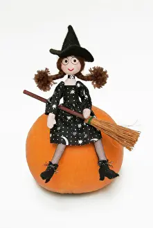 Broom: Witch - with broom sitting on a pumpkin