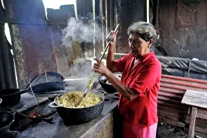 Locals: Woman, 58, preparing tortillas in a simple wood