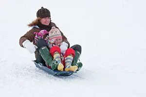 Sledging: Woman and child sledging in deep snow