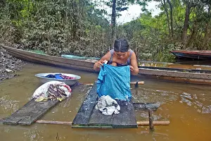 Tribal: woman doing laundry in the river Indian of the Apurina