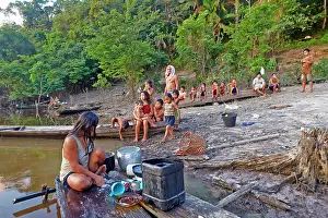 Tribal: Woman doing laundry in the river Indian of the Apurina