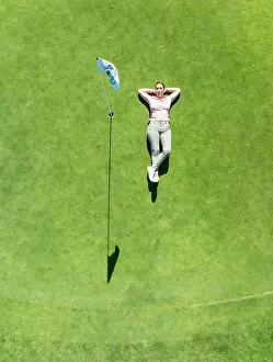 Resort: Woman lying on the green at the La Noria Golf Resort
