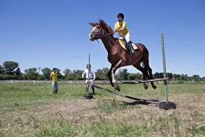 Saddle: Woman making a jump of horse therapy center