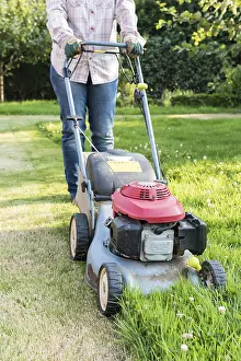 Boundary: Woman mowing a lawn, summer, Pas de Calais, France