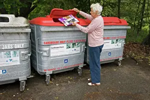 Dustbin: Woman recycling cardboard in recycling bin