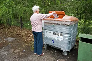 Dustbin: Woman recycling plastic bottles