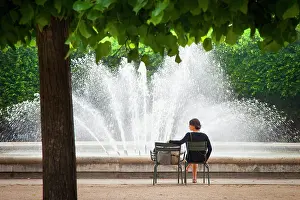 Relax: Woman relaxing at the fountain in the Garden