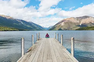 Dock: Woman sitting on dock, view of Lake Rotoiti, Nelson