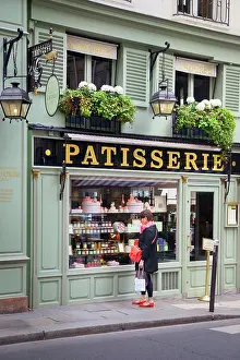 Shop: Woman window shopping at Lauderee Patisserie