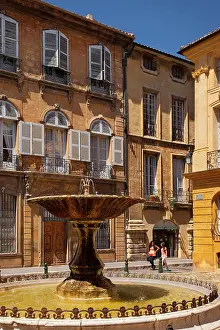 Courtyard: Two women walk past the fountain at Place