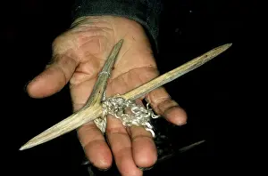 Siberia: Wooden fishing hook on palm of a Siberian shaman/
