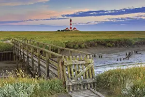 Timber: Wooden footbridge and lighthouse Westerheversand at Westerhe