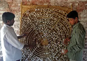 Silkworms: Workers with silkworm coccoons in an Indian silkworm