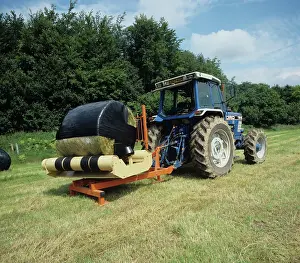 Truck: Wrapping silage bale in plastic