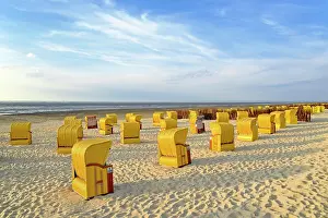 Chairs: Yellow beach chairs in the evening light at the
