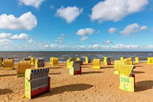 Chairs: Yellow beach chairs at high water on the beach of