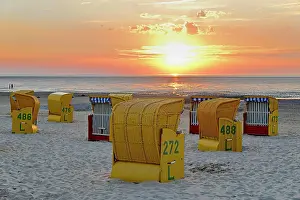 Chairs: Yellow beach chairs at sunset on the beach of Cuxhaven-Dnse