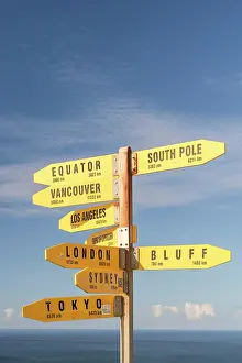 Signs: Yellow signs, signposts with various travel destinations