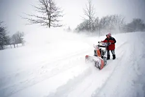 Blower: Young boy digging out from snow storm - using snow