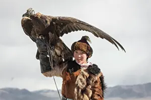 Obedient: Young eagle hunter with her female eagle, Olgii