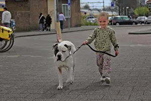 Youth: Young female child walking a dog, Amsterdam