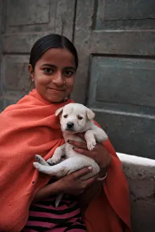 Beard: Young girl carrying a puppy in her arms Haridwar India