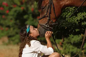 Halter: Young girl cuddling her horse - Senegal