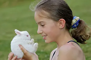 Choosing: Young Girl - holding white Polish rabbit with red eyes
