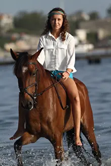 Halter: Young girl riding bareback in the sea - Senegal
