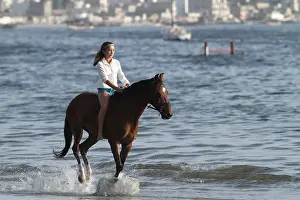 Halter: Young girl riding bareback in the sea - Senegal