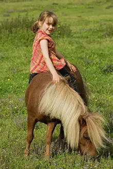 Minature: Young girl riding Shetland Pony